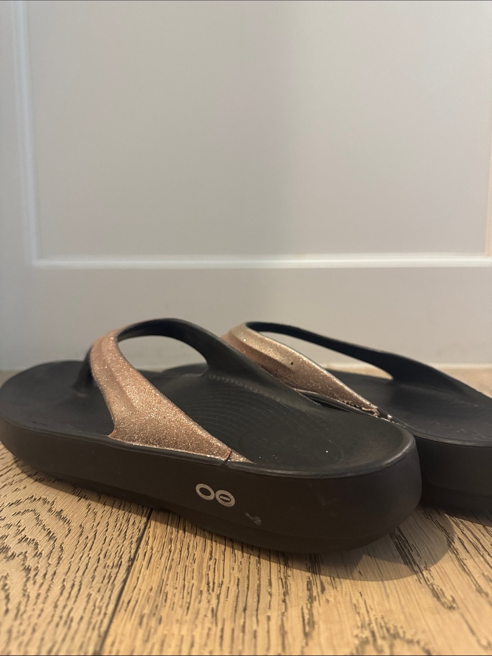 OOFOS Women's Black Foam Flip Flops with Glitter Rose Gold Straps